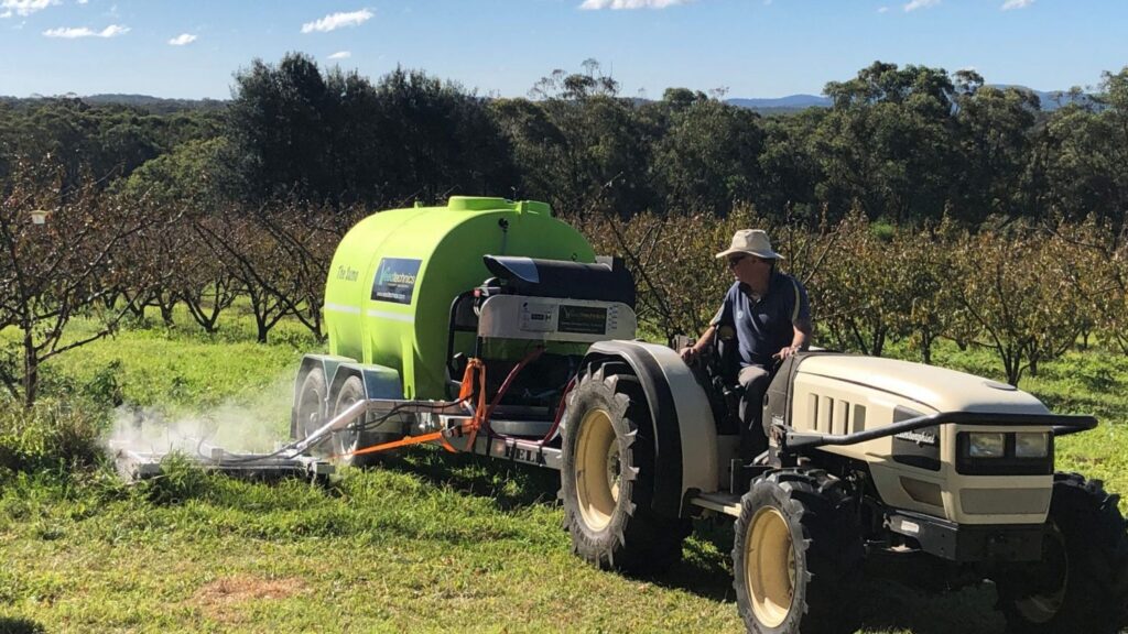 Image of Weedtechnics applying Satusteam™ to a piece of land.In this image, the Weedtechnics team expertly applies Satusteam™, a groundbreaking innovation in sustainable weed control, to a patch of land. Satusteam™, a potent blend of saturated steam and boiling water, revolutionizes the way we combat weeds without compromising soil health or sustainability.Satusteam™ employs high temperatures, ranging from 90 to 120 degrees Celsius, to target and obliterate weed cells, leaving them wilted and vulnerable to natural decomposition by microorganisms. As these weeds break down, they contribute valuable nutrients back into the soil, fortifying it for the growth of crops and vegetables. What sets Satusteam™ apart is its gentle approach to soil preservation. It's a surface treatment, reaching only 5 to 10 mm deep, thereby maintaining the soil's temperature stability. This method safeguards against detrimental impacts on the root system and overall soil health. While Satusteam™ excels at surface weed control, there may be situations where deep-rooted or fibrous weeds persist. In such cases, deeper penetration into the root zone may be necessary, ensuring thorough and effective weed elimination while still prioritizing soil integrity and sustainability.